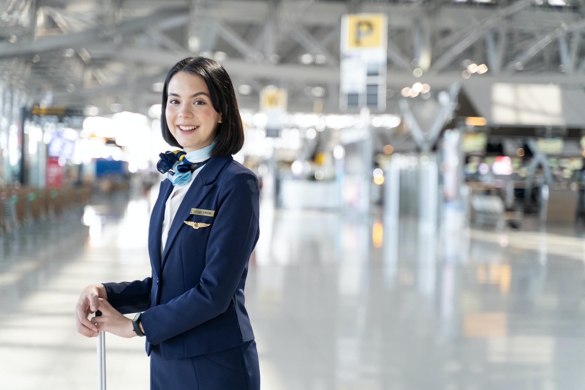 Portrait of Caucasian flight attendant standing in airport terminal.